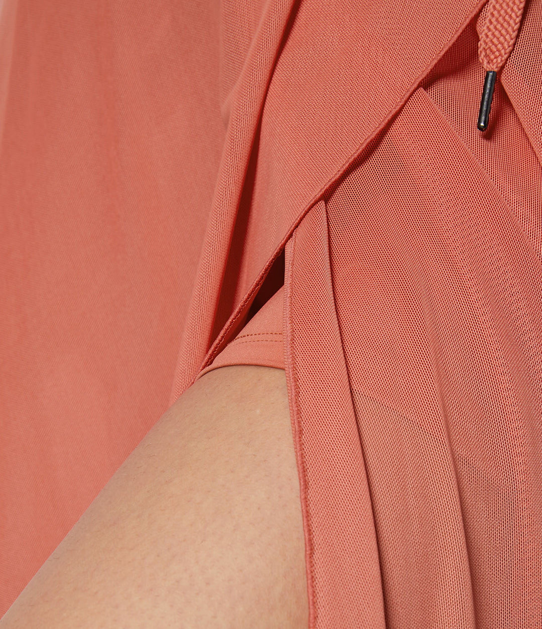 A woman in an elegant high-waisted flowing skirt, styled for a versatile day-to-evening look.