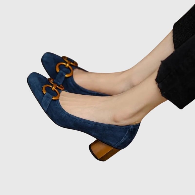 A woman wearing elegant high heels with a tailored evening outfit