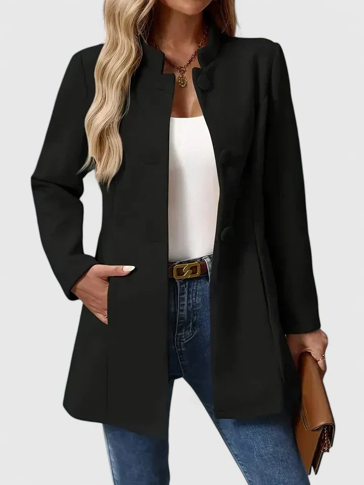 A woman wearing a tailored jacket with a neat stand collar and a button front