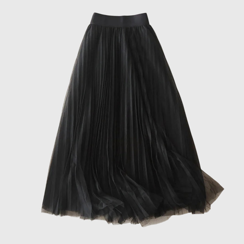 A woman in a flowing layered flared skirt, styled elegantly for a special day-to-night look.