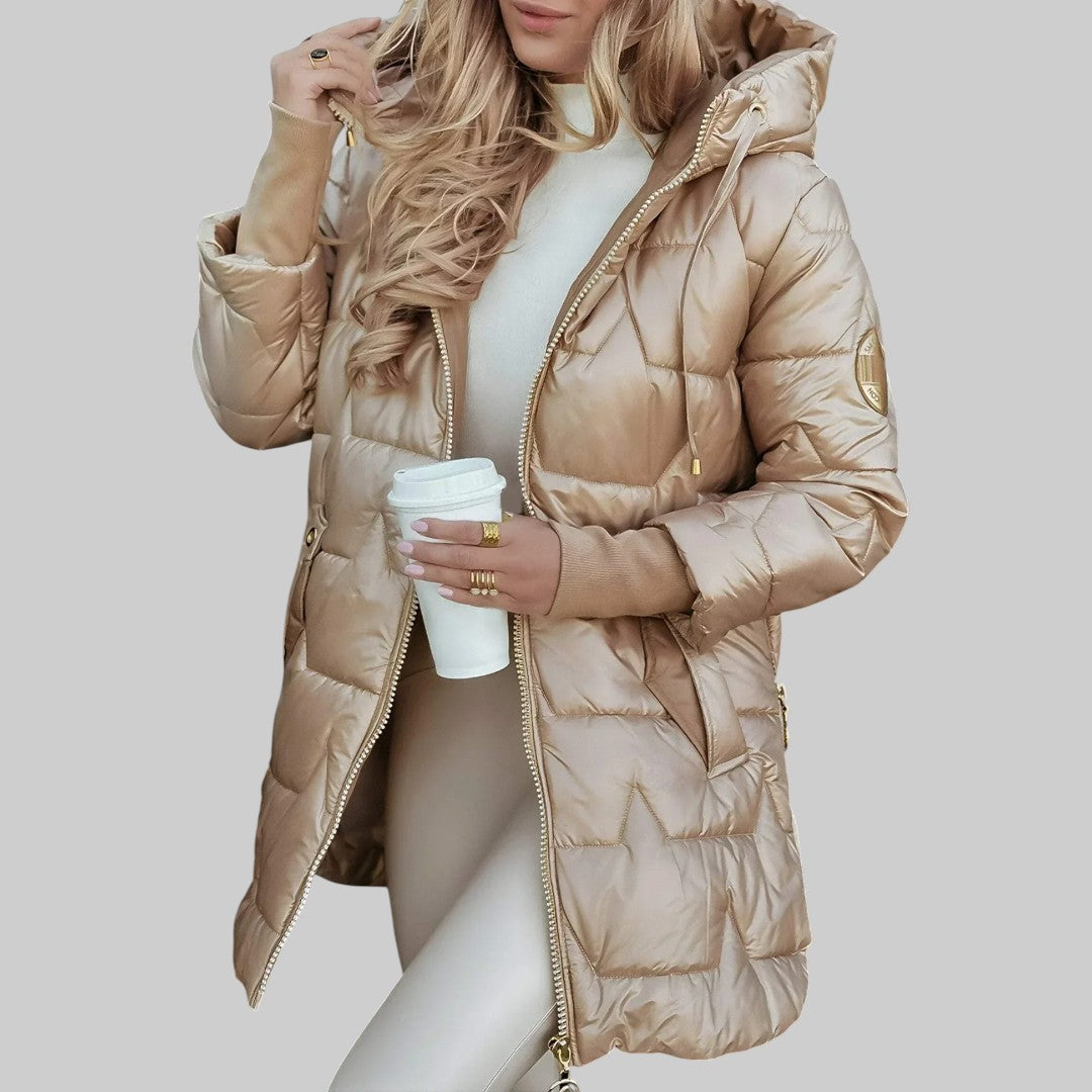 A woman wearing a hooded fall coat in a timeless tone, sheltered from the wind.