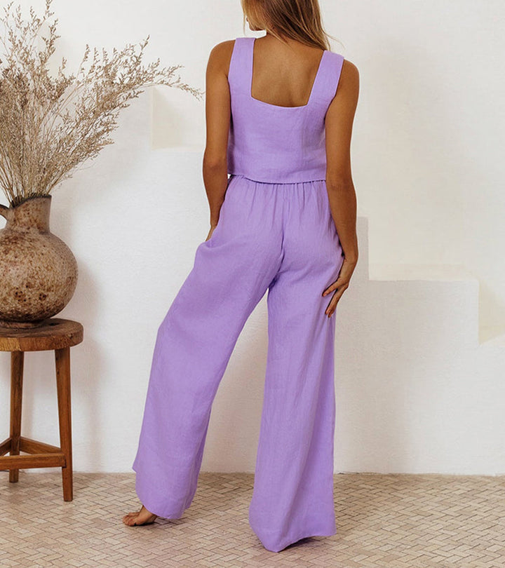A woman wearing a minimal two-piece set with a square neckline and belted flared pants.