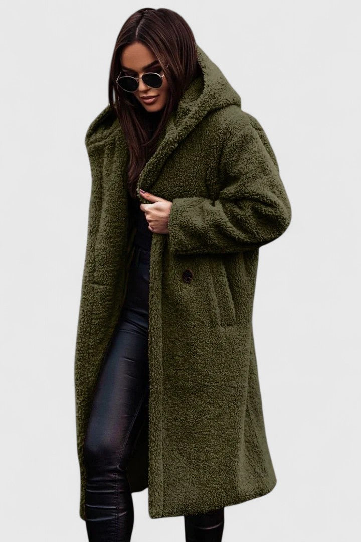 A woman wearing a long, softly textured hooded winter coat with an open front
