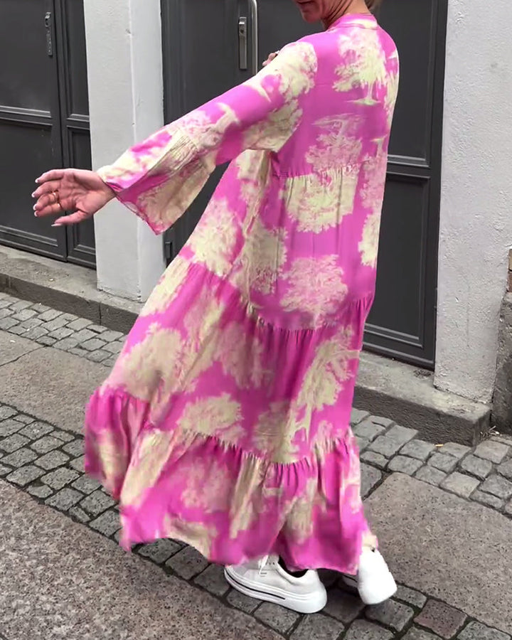 Woman wearing the Sylvie flowing maxi dress with a delicate print and V-neckline, the skirt moving softly as she walks.