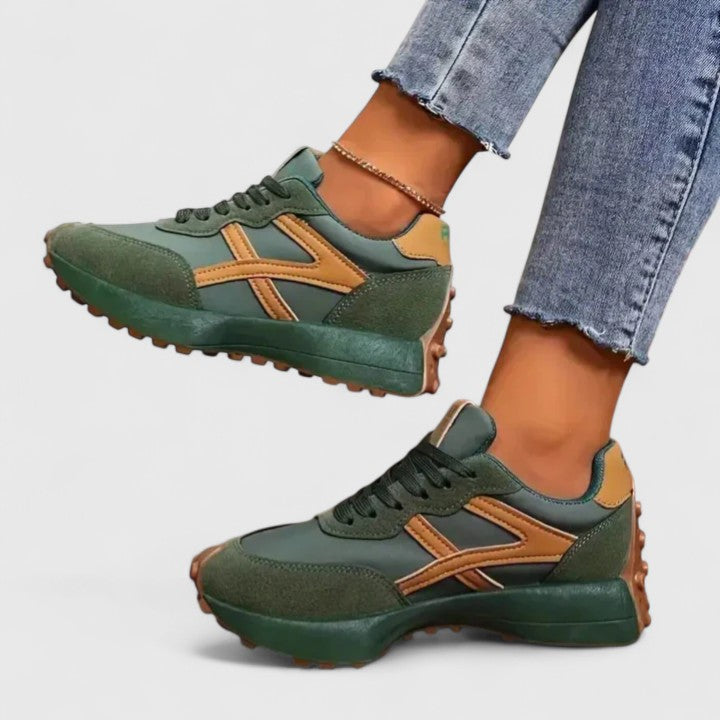 A woman wearing neutral contrast orthopaedic sneakers on a city walk.