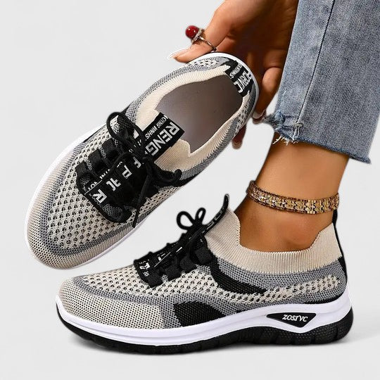 A woman lacing up light, breathable orthopaedic sneakers before a walk.