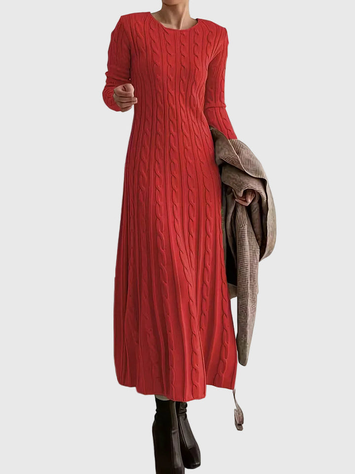Woman wearing the Emily cable-texture maxi dress in soft cream, styled with boots.