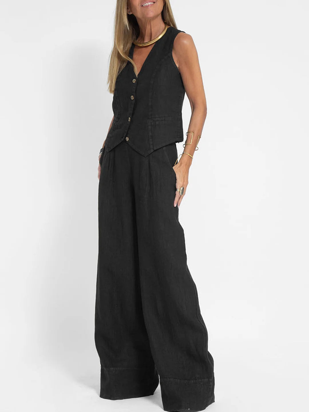 A woman wearing a tailored waistcoat with flowing wide-leg pants