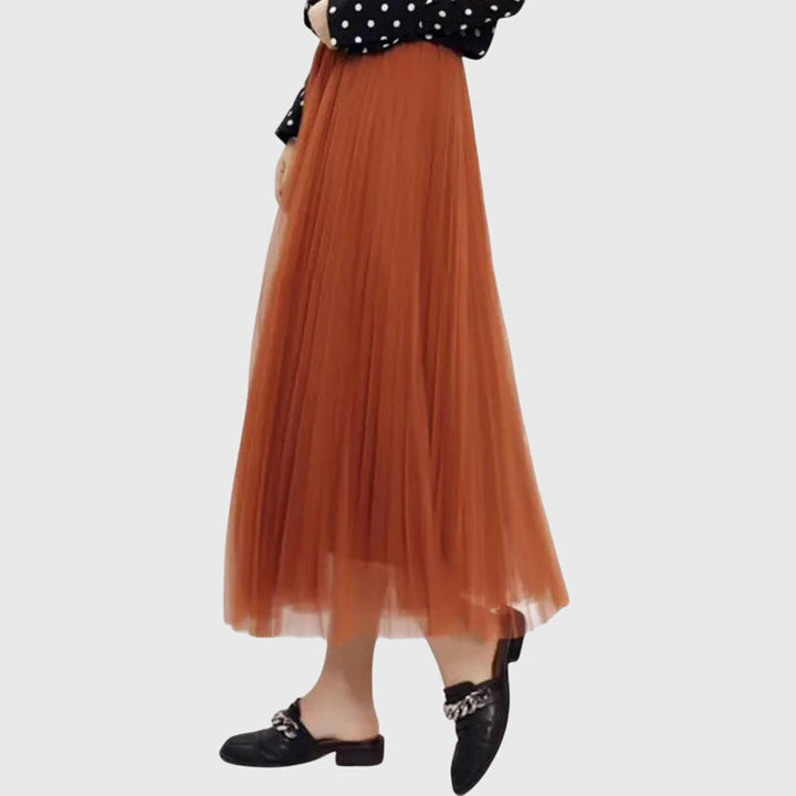 A woman in a flowing layered flared skirt, styled elegantly for a special day-to-night look.