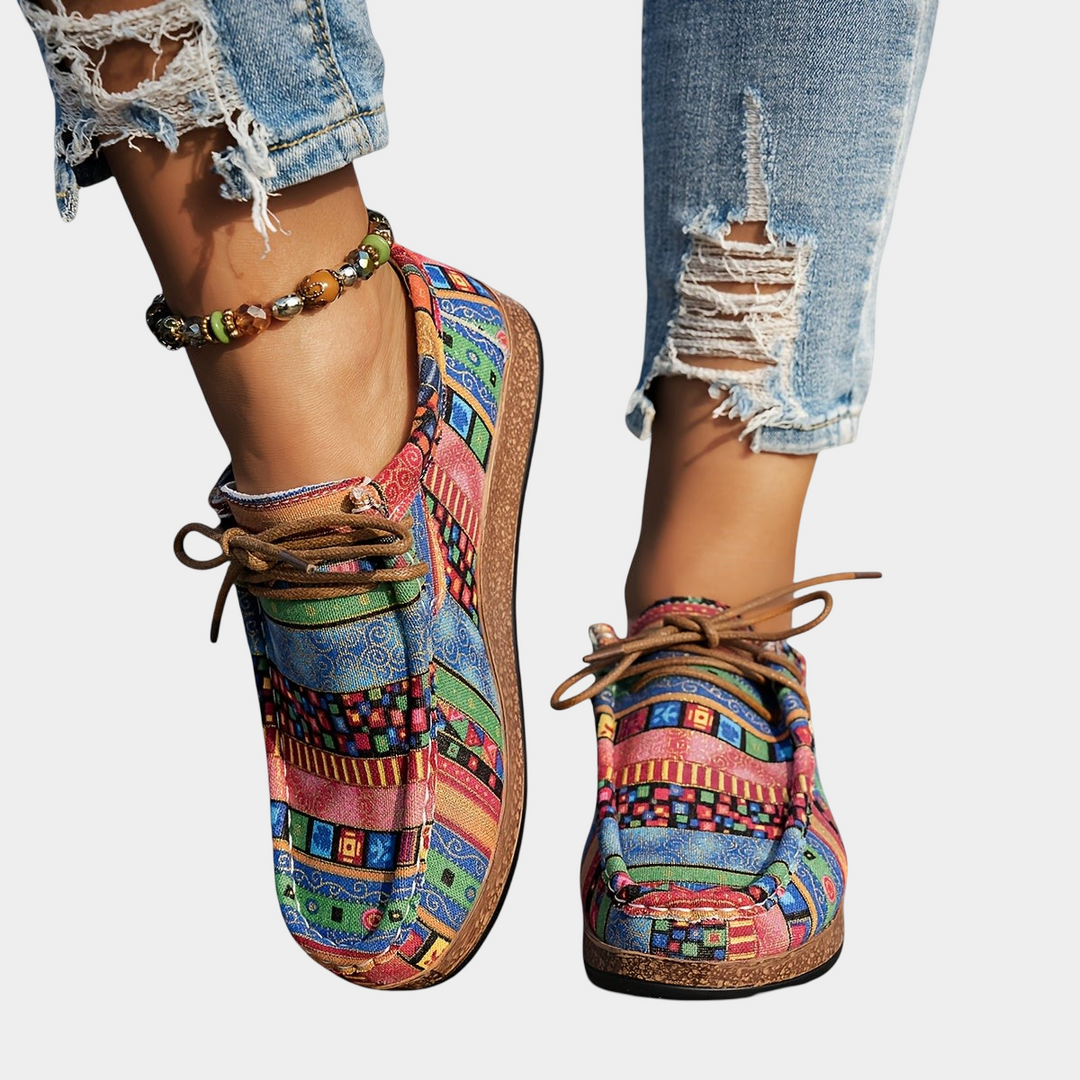 A woman wearing green boho-patterned lightweight sneakers on a walk in town.
