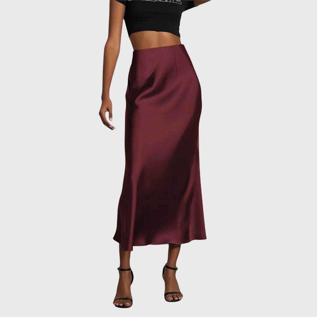 A woman in a fitted fishtail skirt with a flared hem, styled elegantly for a special occasion.