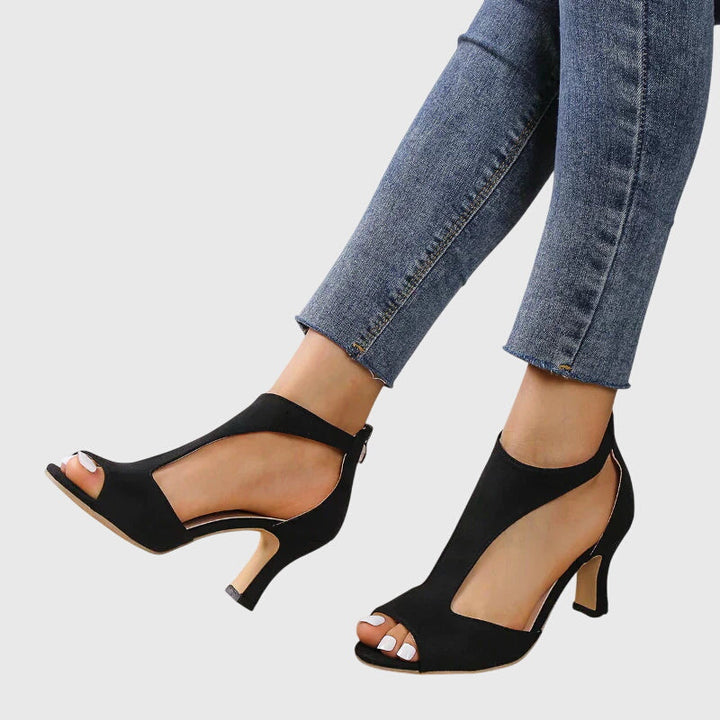 A woman in soft pink supportive heels walking with ease through her day.