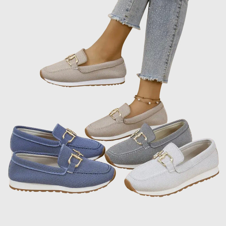 A woman in smart-casual orthopaedic loafer sneakers with a subtle golden detail.