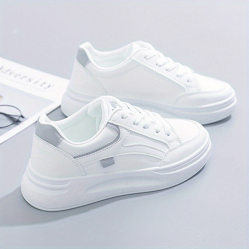 A woman in crisp white light comfort sneakers paired with jeans.