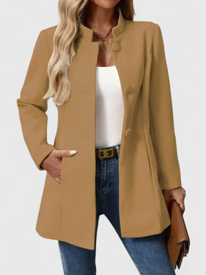 A woman wearing a tailored jacket with a neat stand collar and a button front