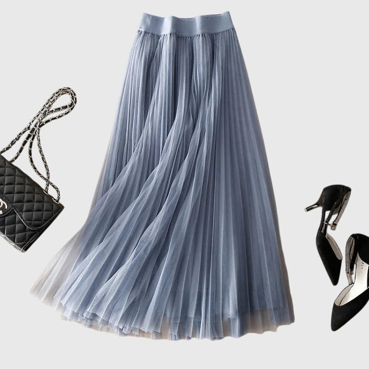 A woman in a flowing layered flared skirt, styled elegantly for a special day-to-night look.