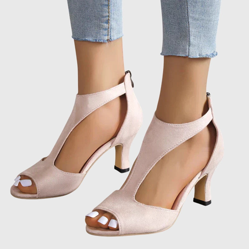 A woman in soft pink supportive heels walking with ease through her day.