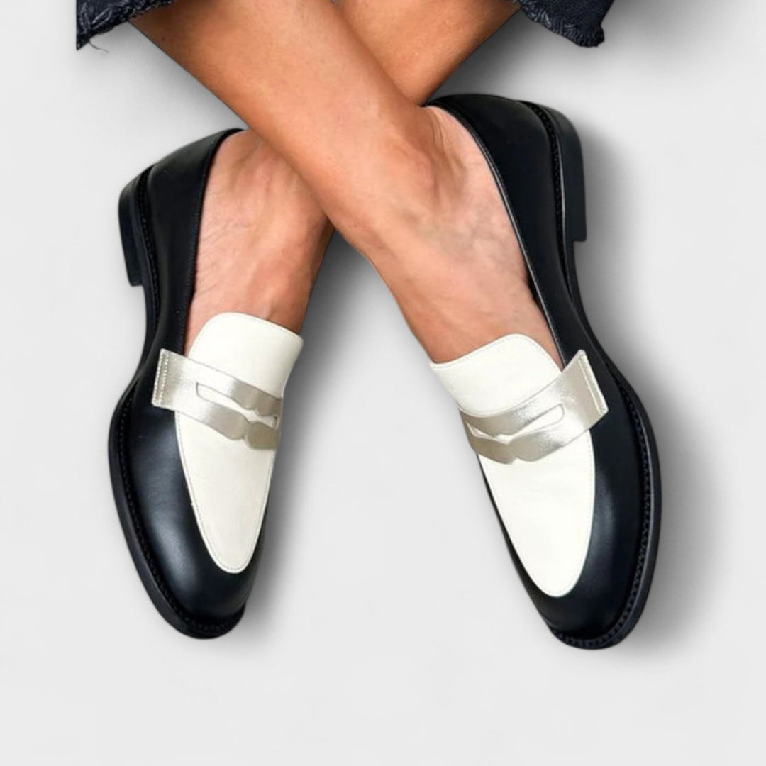 A woman wearing black metallic-shimmer loafers on an elegant evening out.