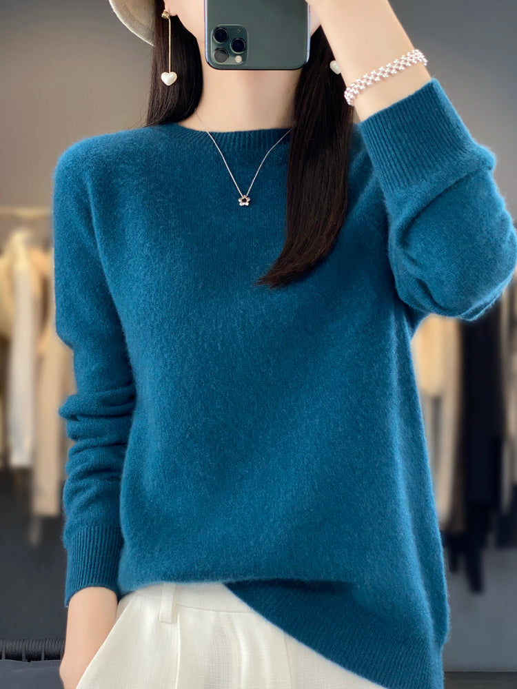 A woman wearing a super-soft warm sweater, relaxed and cosy on a chilly day.