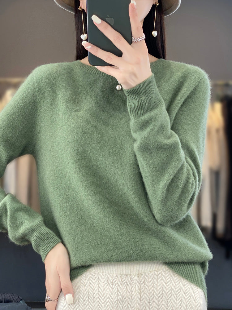 A woman wearing a super-soft warm sweater, relaxed and cosy on a chilly day.