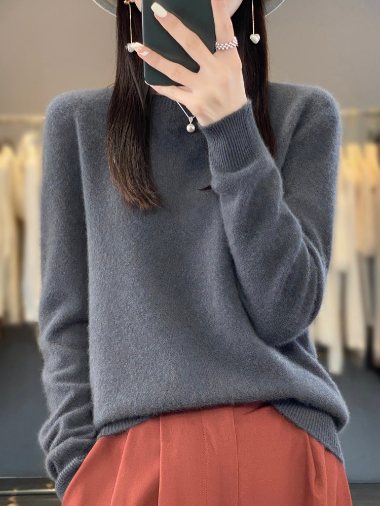 A woman wearing a super-soft warm sweater, relaxed and cosy on a chilly day.