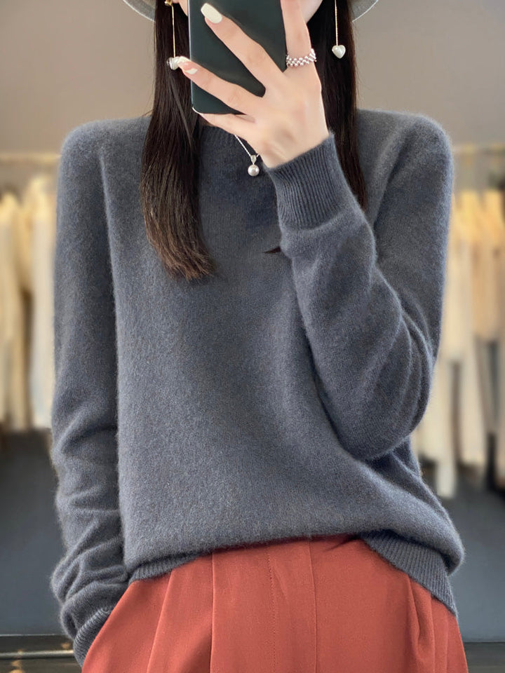 A woman wearing a super-soft warm sweater, relaxed and cosy on a chilly day.