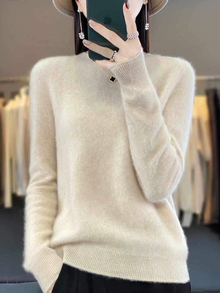 A woman wearing a super-soft warm sweater, relaxed and cosy on a chilly day.