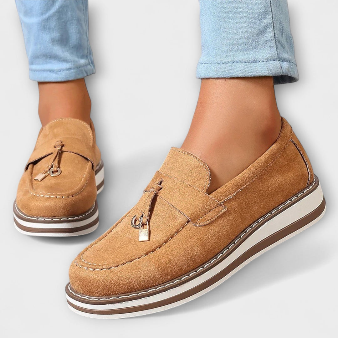 A woman wearing soft round-toe casual loafers with a relaxed everyday outfit