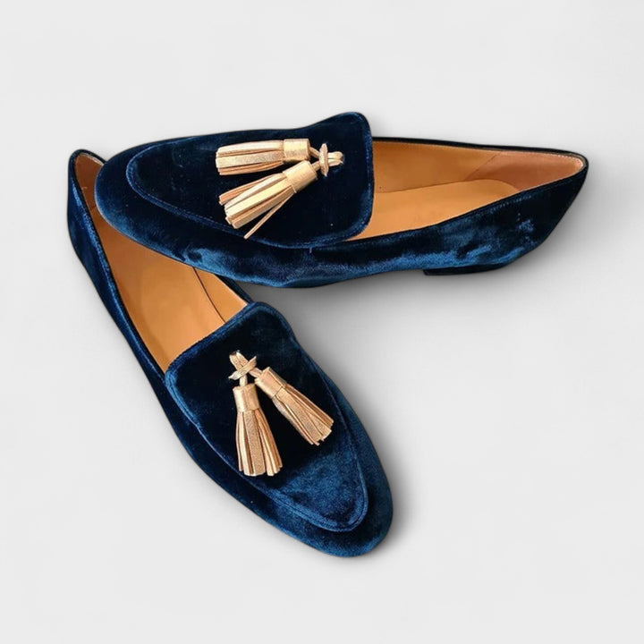 A woman wearing vintage-style loafers with decorative tassels and a relaxed outfit