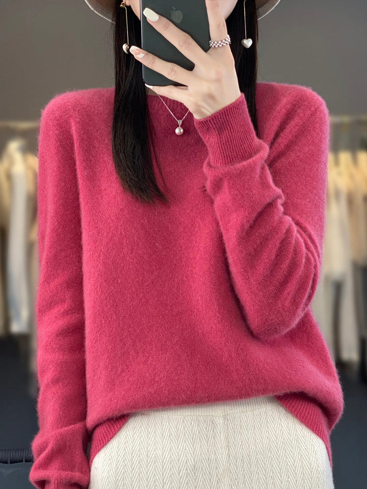 A woman wearing a super-soft warm sweater, relaxed and cosy on a chilly day.