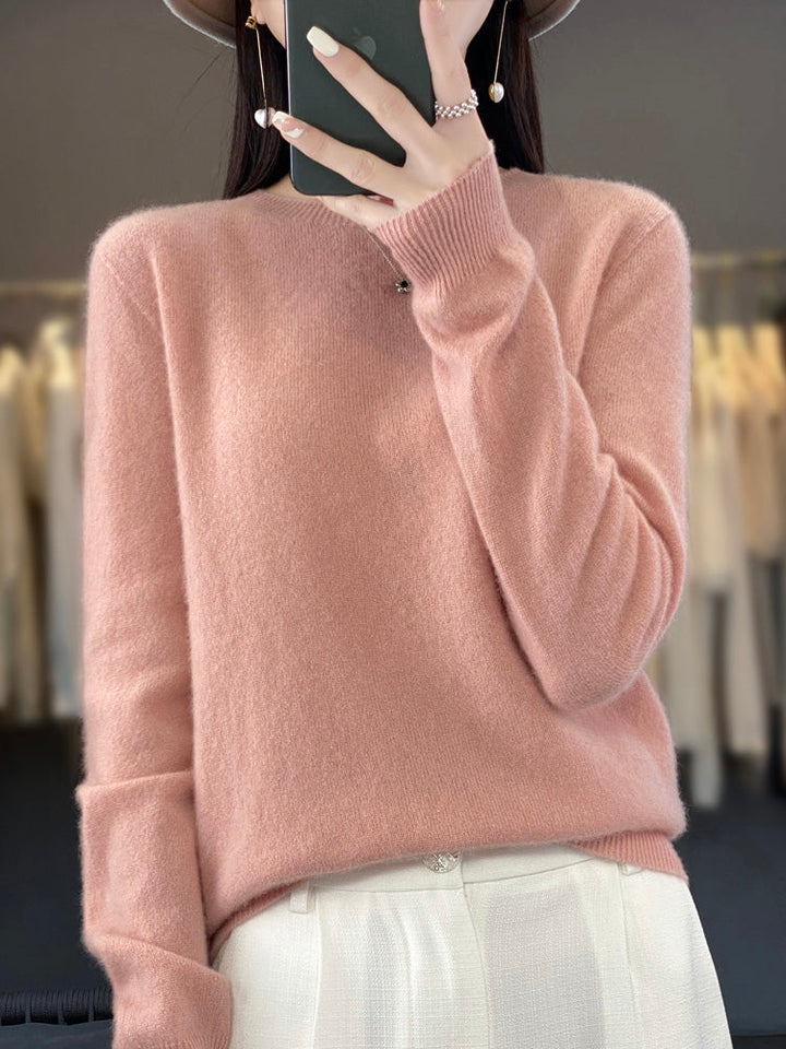 A woman wearing a super-soft warm sweater, relaxed and cosy on a chilly day.