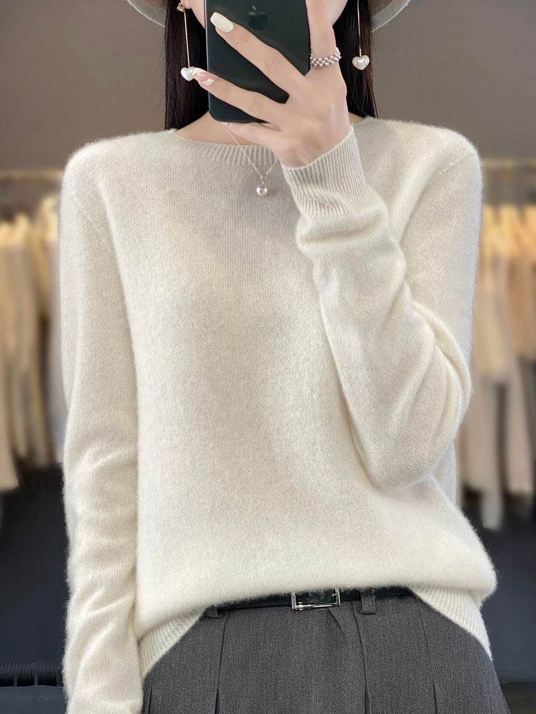 A woman wearing a super-soft warm sweater, relaxed and cosy on a chilly day.