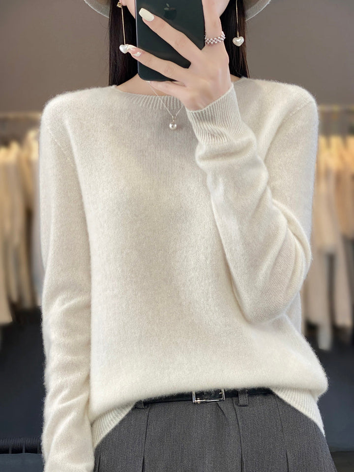 A woman wearing a super-soft warm sweater, relaxed and cosy on a chilly day.