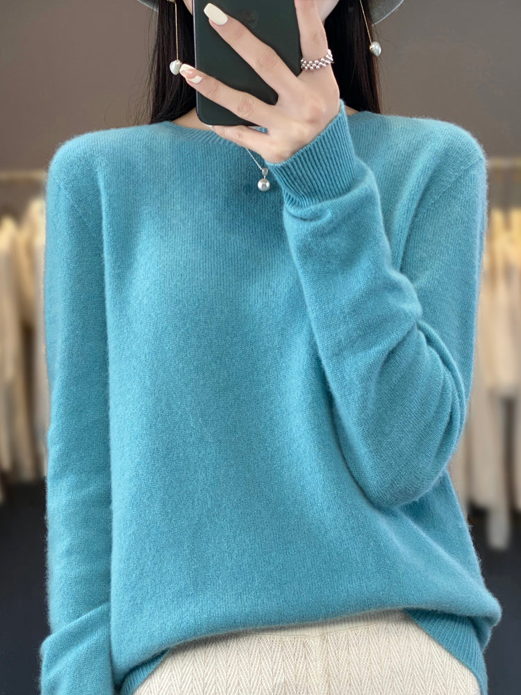 A woman wearing a super-soft warm sweater, relaxed and cosy on a chilly day.