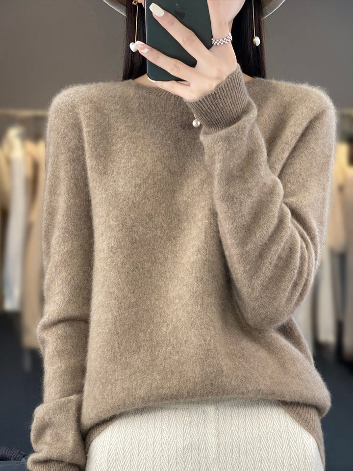 A woman wearing a super-soft warm sweater, relaxed and cosy on a chilly day.