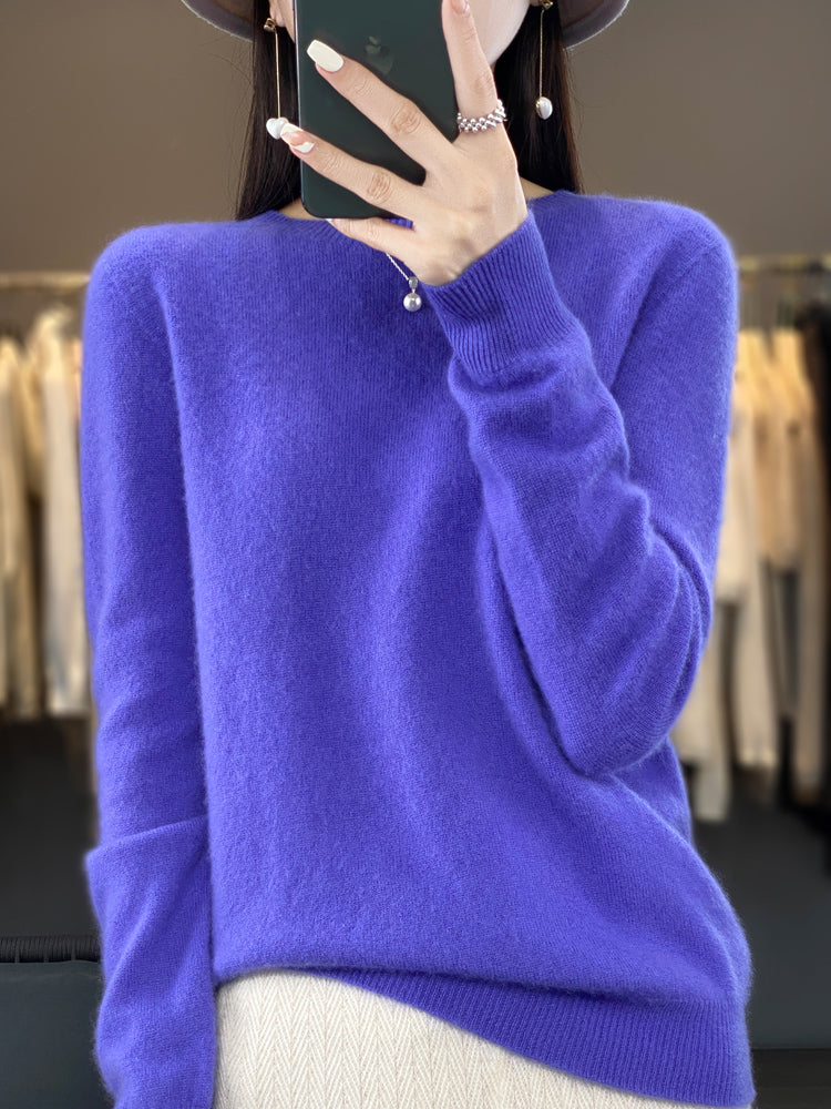 A woman wearing a super-soft warm sweater, relaxed and cosy on a chilly day.