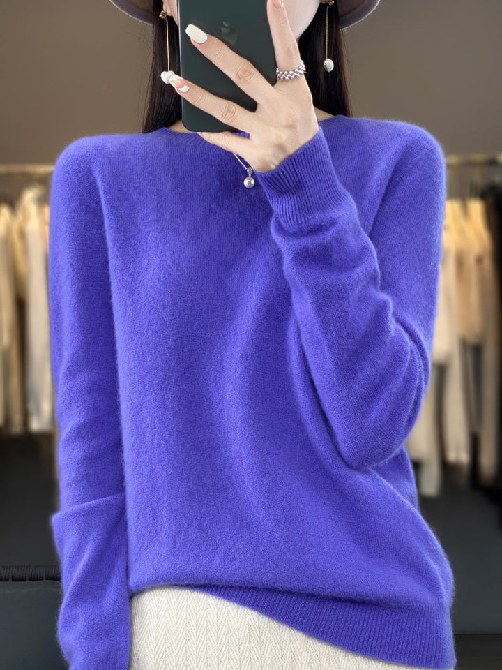 A woman wearing a super-soft warm sweater, relaxed and cosy on a chilly day.