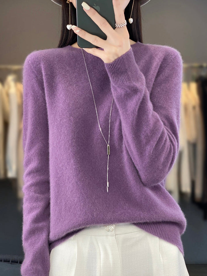 A woman wearing a super-soft warm sweater, relaxed and cosy on a chilly day.