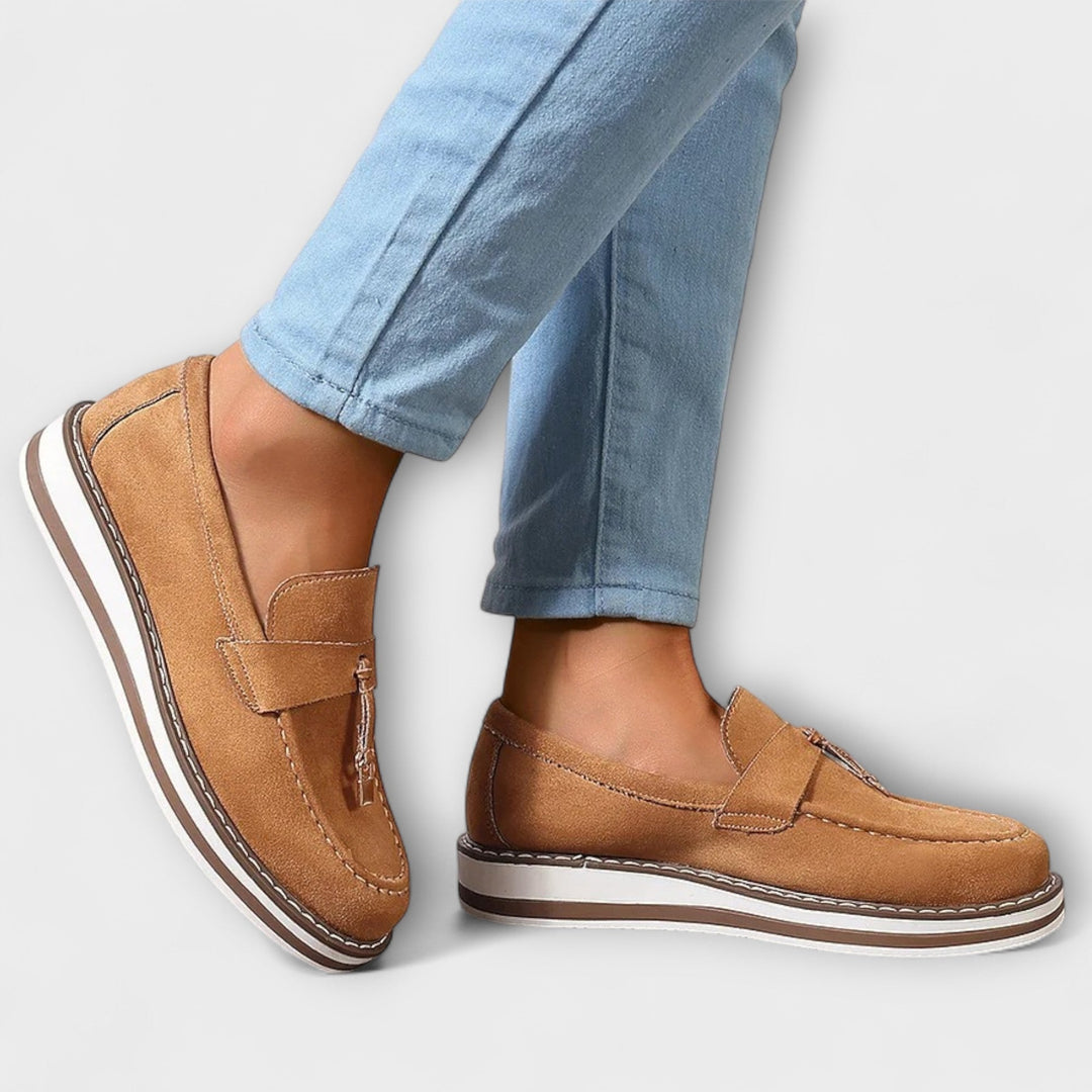 A woman wearing soft round-toe casual loafers with a relaxed everyday outfit