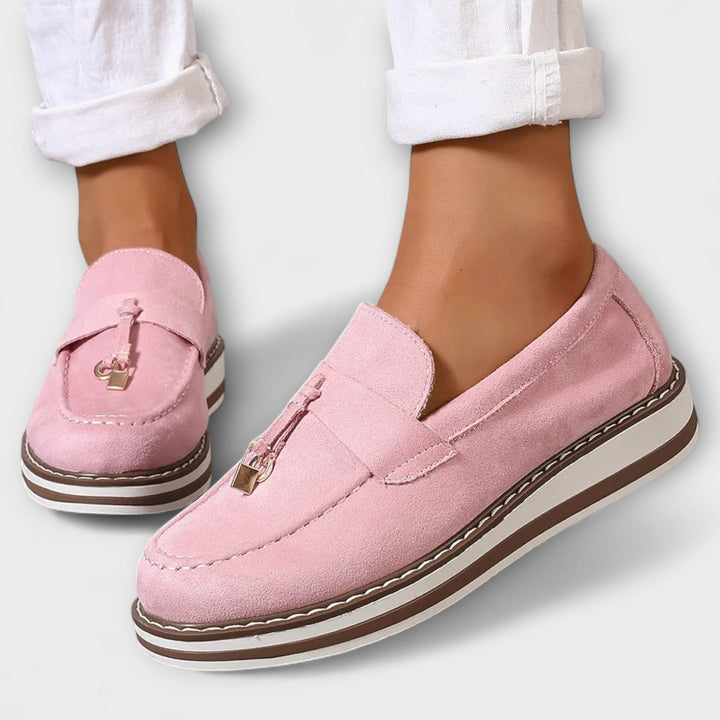 A woman wearing soft round-toe casual loafers with a relaxed everyday outfit