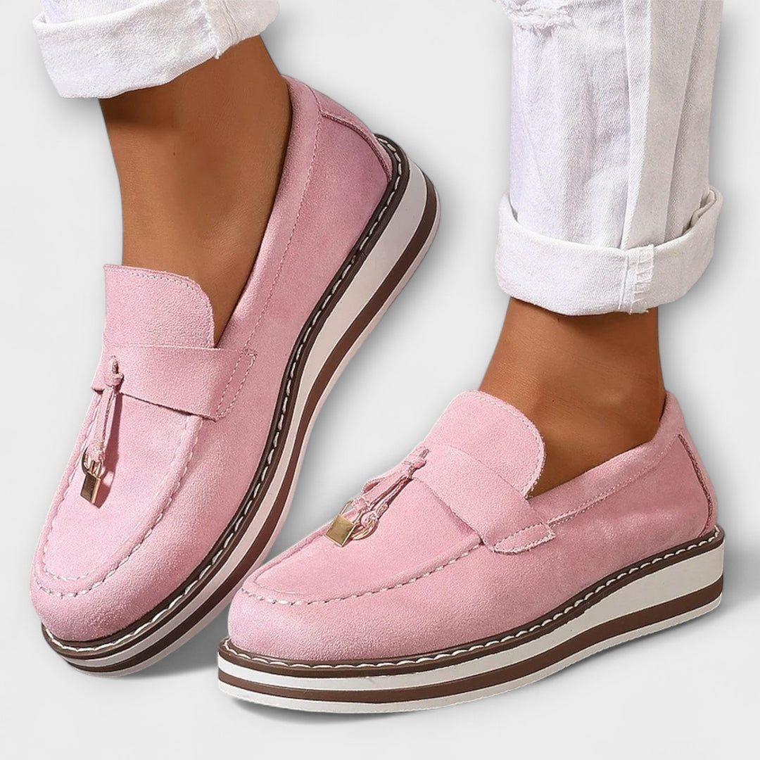 A woman wearing soft round-toe casual loafers with a relaxed everyday outfit