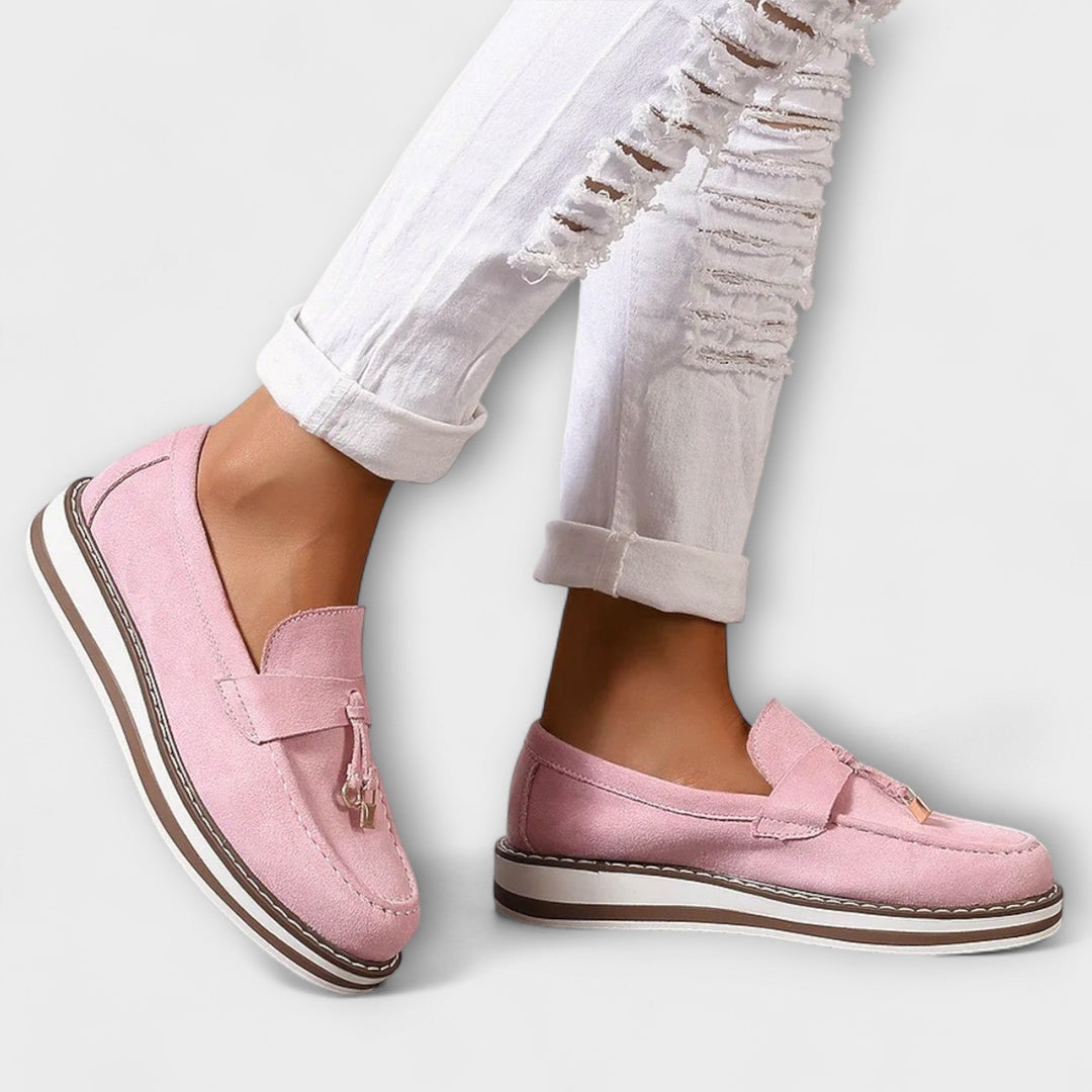 A woman wearing soft round-toe casual loafers with a relaxed everyday outfit