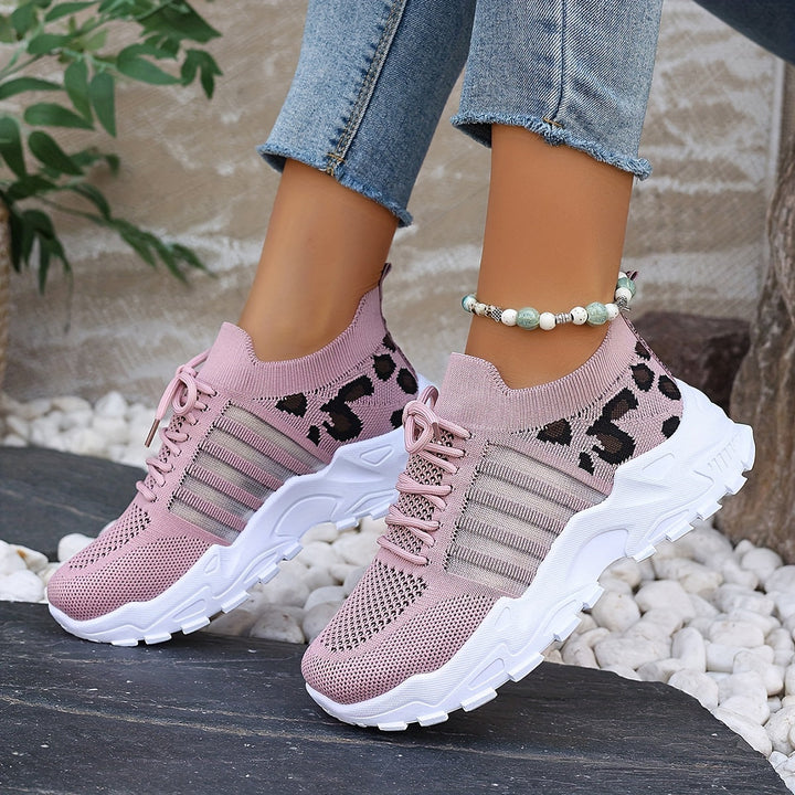 A woman walking in light, breathable comfort sneakers on a warm day.