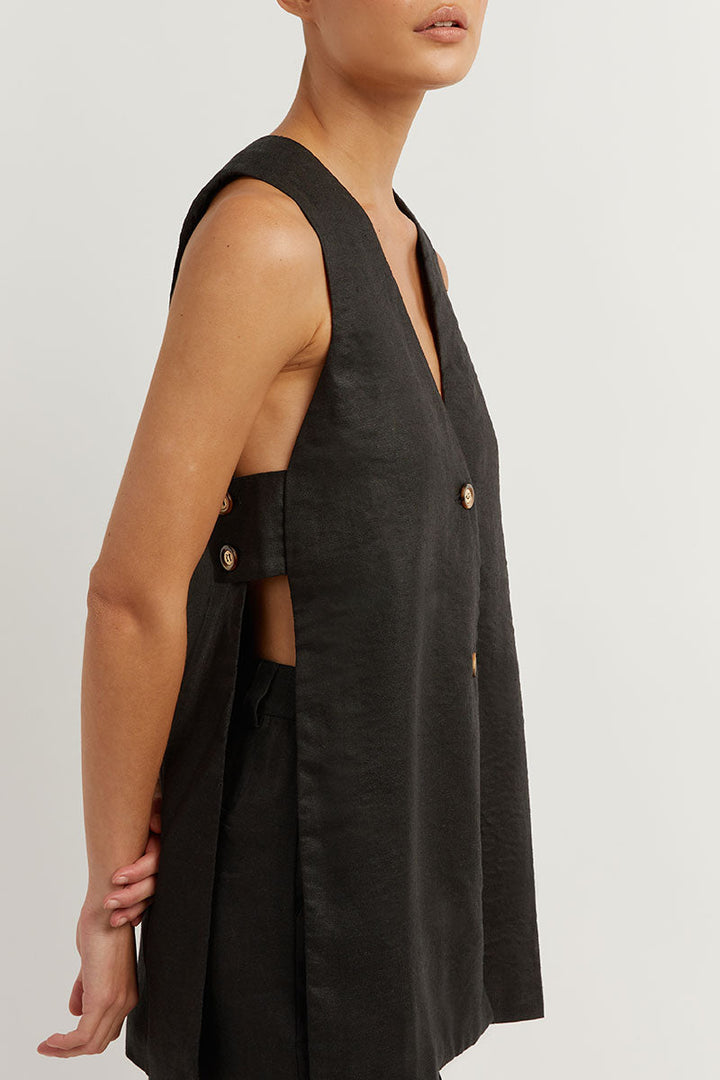 A woman wearing a sleeveless buttoned two-piece set