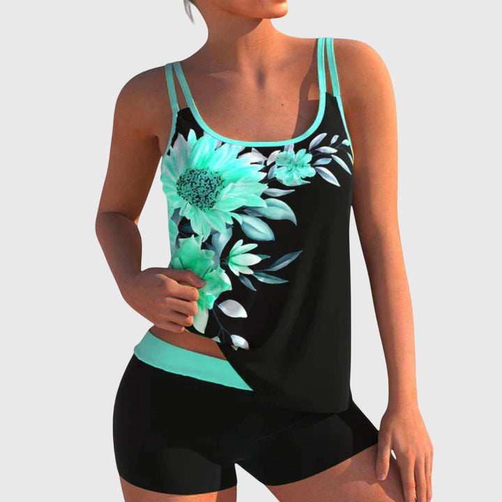 A woman by the water in a fresh printed two-piece swimsuit, relaxed and confident in the sun.