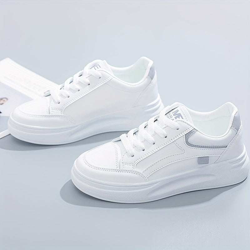 A woman in crisp white light comfort sneakers paired with jeans.