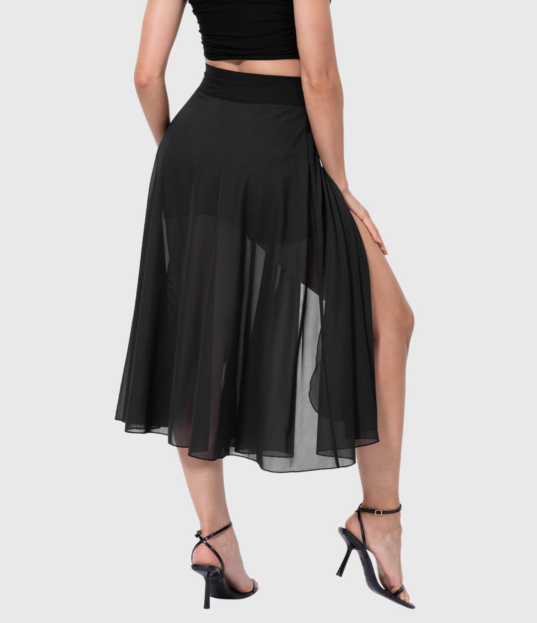 A woman in an elegant high-waisted flowing skirt, styled for a versatile day-to-evening look.