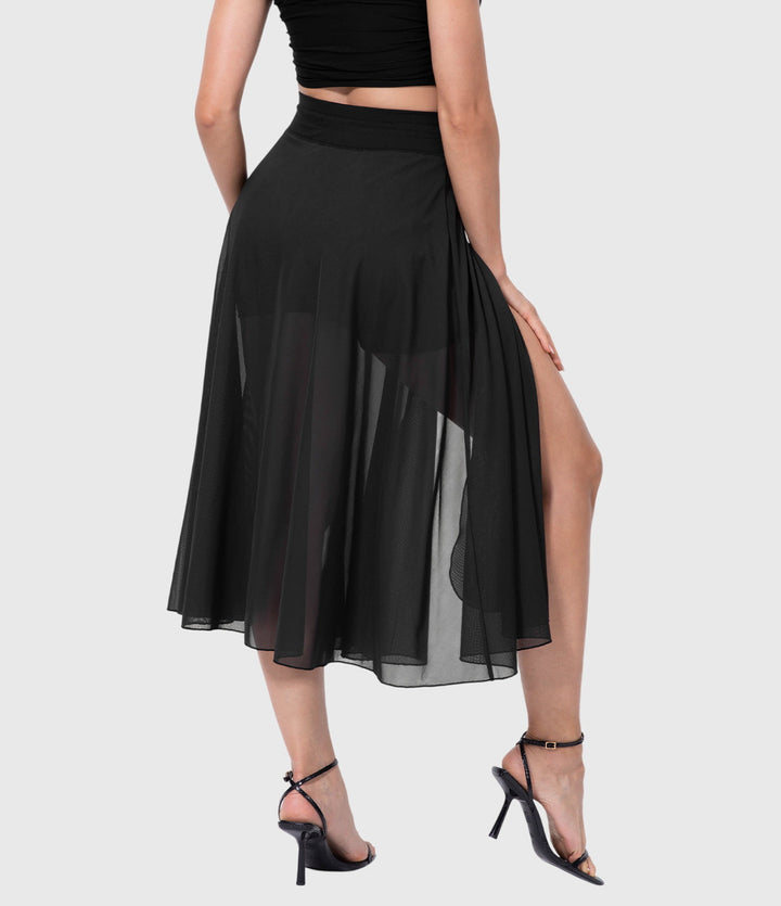 A woman in an elegant high-waisted flowing skirt, styled for a versatile day-to-evening look.