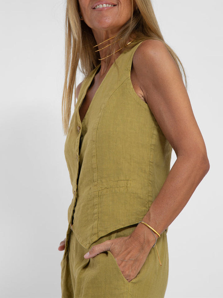 A woman wearing a tailored waistcoat with flowing wide-leg pants