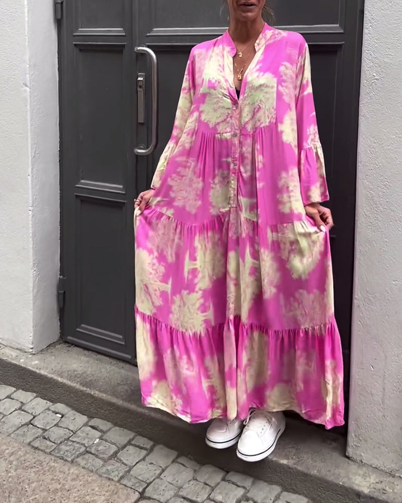 Woman wearing the Sylvie flowing maxi dress with a delicate print and V-neckline, the skirt moving softly as she walks.
